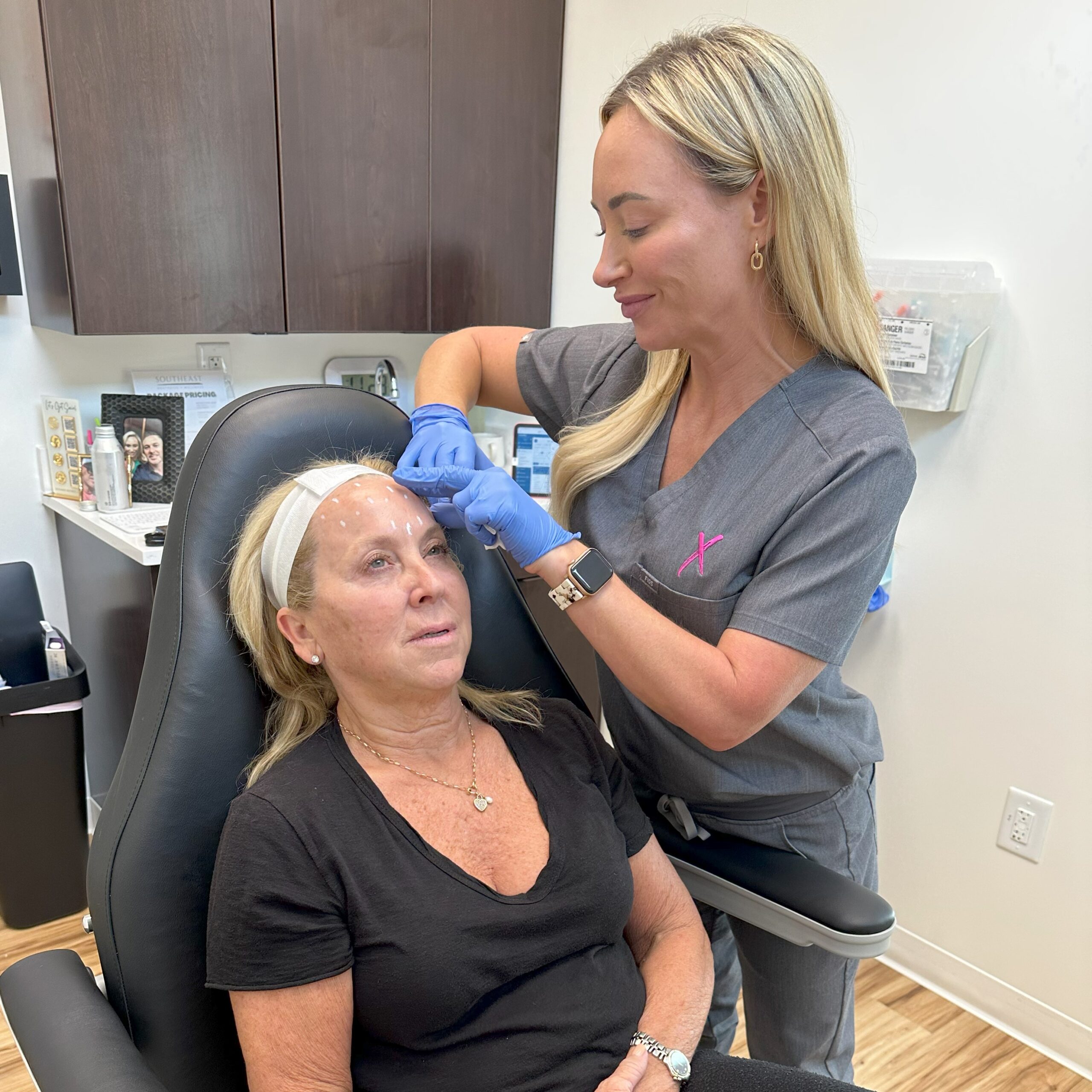 A woman receiving a neuromodulator injection in her face