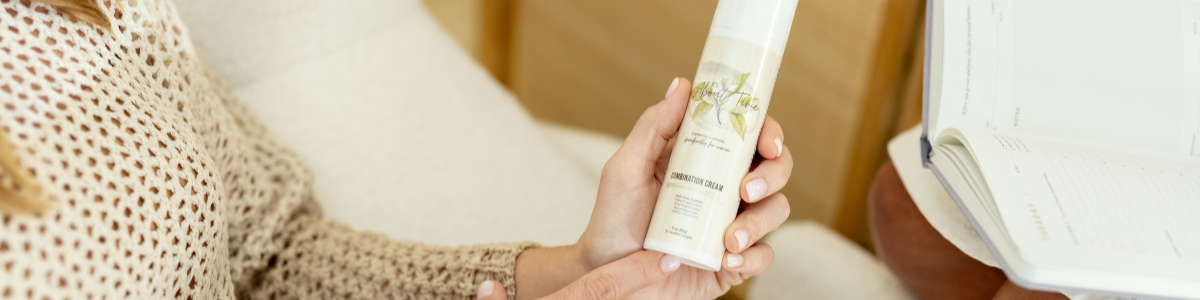 Woman holding progesterone cream in hand as a treatment for the perimenopause symptoms she is experiencing