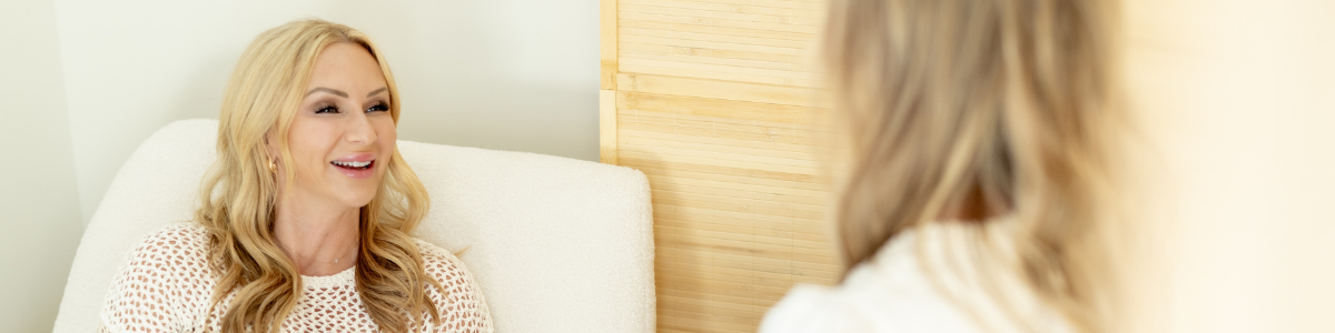 Woman consulting professional, Angel Turlington, about perimenopause symptoms